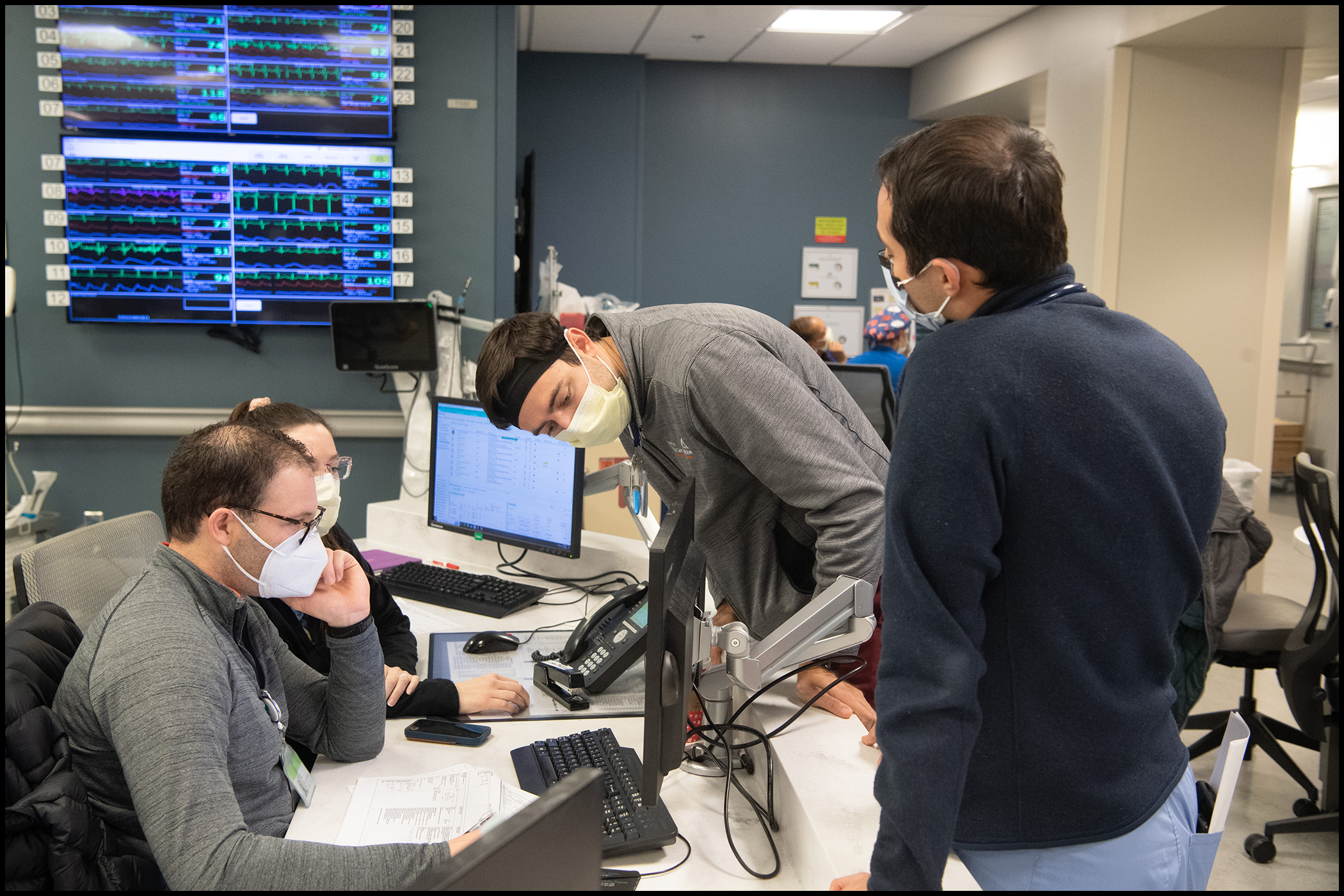 clinicians at their hall station working on computers