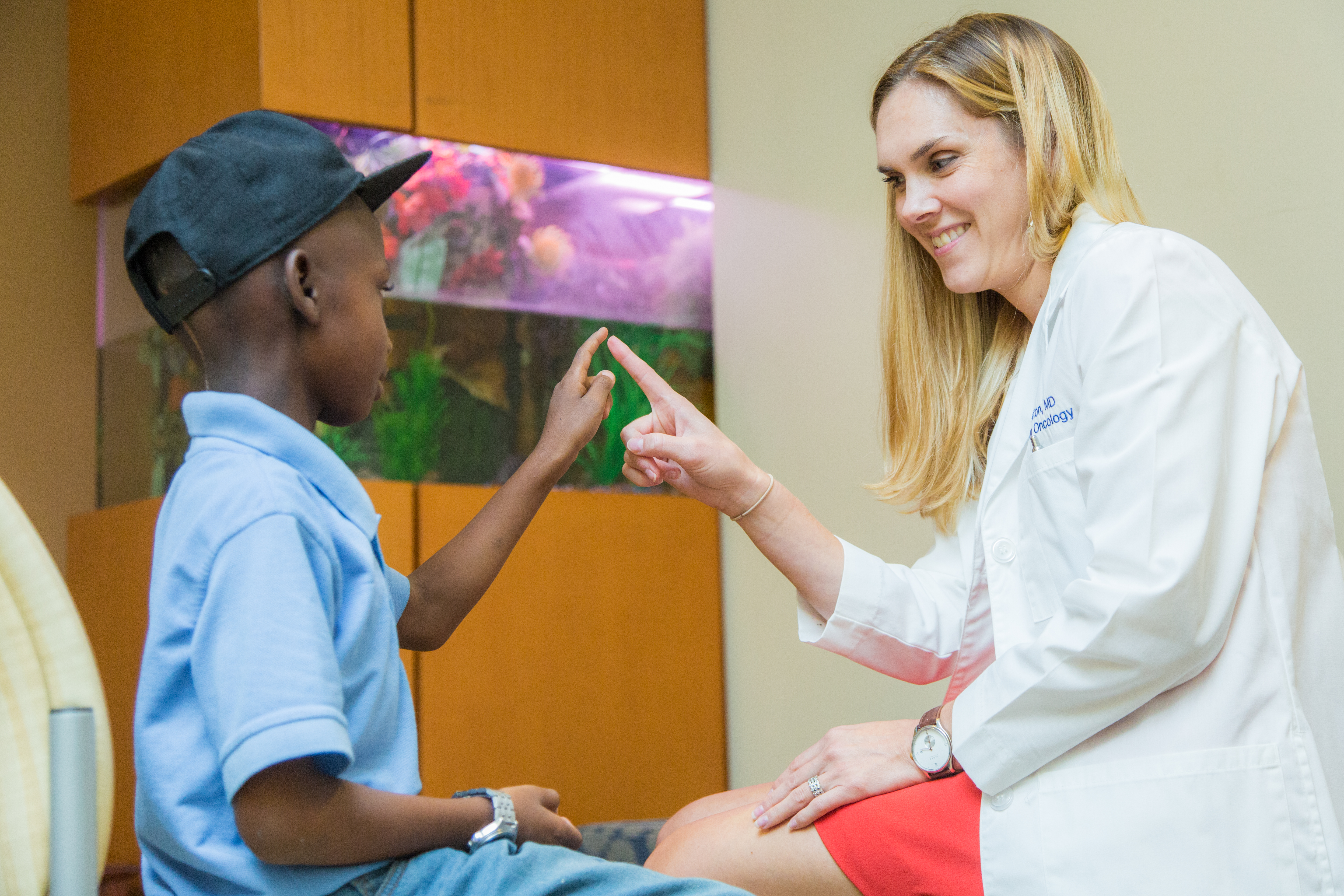 female doctor treating a male child patient